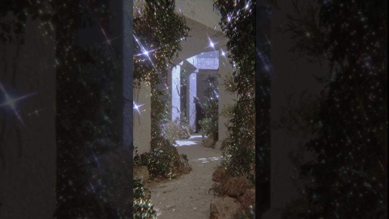 liminal outdoor passage, narrow path leading forward, transitional space, viewer positioned behin...